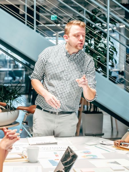 Man standing at desk talking